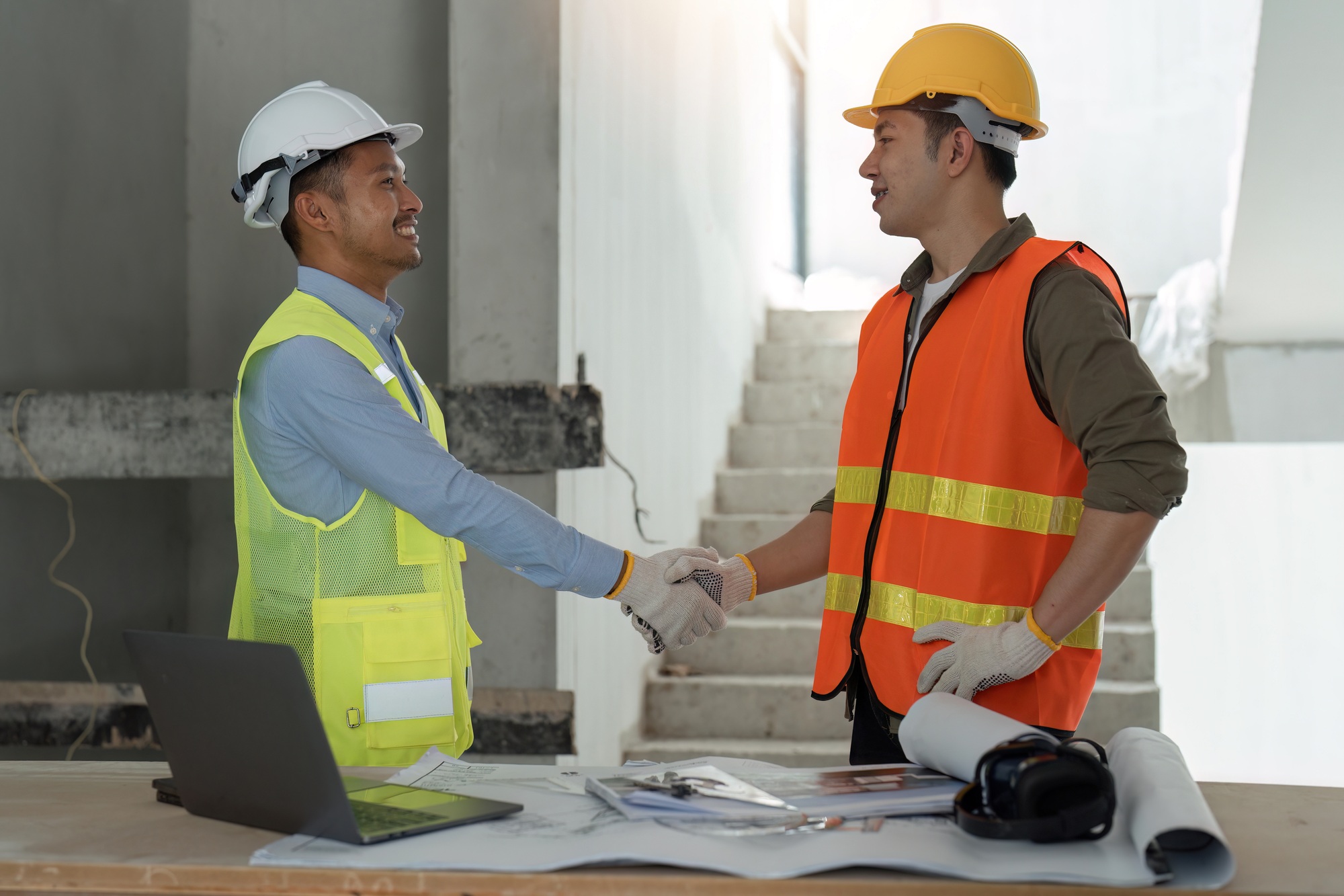 construction worker team hands shaking after consultation meeting to start up plan new project